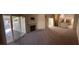 Spacious living room with a fireplace and sliding glass door to the patio at 10321 Birch Bluff Ln, Las Vegas, NV 89145