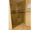 Modern tiled shower with glass door and built-in corner shelf at 10321 Birch Bluff Ln, Las Vegas, NV 89145
