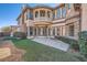 Two-story home featuring manicured green space and paver patio at 10332 Sweet Laurel St, Las Vegas, NV 89178