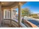 Home's balcony with stone columns overlooking tree lined street, providing a serene outdoor space at 10332 Sweet Laurel St, Las Vegas, NV 89178