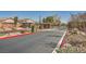 Gated community entrance with decorative iron gates, landscaped areas, and a paved entry road at 10332 Sweet Laurel St, Las Vegas, NV 89178