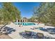 Inviting community pool area featuring lounge chairs, tables, shade structures, and lush landscaping at 10332 Sweet Laurel St, Las Vegas, NV 89178