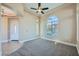 Inviting Living room featuring plush carpeting, large windows, and a ceiling fan at 10332 Sweet Laurel St, Las Vegas, NV 89178