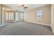 Spacious main bedroom with plush carpet, ceiling fan, and large windows for natural light at 10332 Sweet Laurel St, Las Vegas, NV 89178