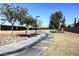 Scenic community walking path with mature trees, landscaping, and well-maintained sidewalks at 10332 Sweet Laurel St, Las Vegas, NV 89178