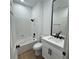 Clean bathroom features a shower-tub combo with sleek black hardware and white vanity at 10405 Junction Hill Dr, Las Vegas, NV 89134