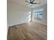 Bright bedroom with modern laminate flooring, a contemporary ceiling fan, and a view of the backyard at 10405 Junction Hill Dr, Las Vegas, NV 89134