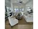 Bright living room featuring high ceilings, a modern fireplace, and comfortable seating arrangement at 10405 Junction Hill Dr, Las Vegas, NV 89134