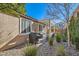 Backyard patio featuring a pergola, outdoor grill, and lush landscaping with green plants and desert stone at 1045 Chestnut Chase St, Las Vegas, NV 89138
