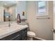 Bathroom with a modern vanity, quartz countertop, and walk-in shower with glass door and brushed nickel fixtures at 1045 Chestnut Chase St, Las Vegas, NV 89138