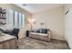 Bright bedroom with a neutral color scheme, comfortable seating, and a large window at 1045 Chestnut Chase St, Las Vegas, NV 89138