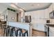 Modern kitchen features stainless steel appliances, a breakfast bar, and sleek white cabinetry at 1045 Chestnut Chase St, Las Vegas, NV 89138