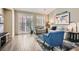 Bright living area featuring wood floors, a modern rug, and lots of natural light at 1045 Chestnut Chase St, Las Vegas, NV 89138