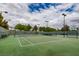 Well-maintained outdoor tennis court surrounded by mature trees and greenery at 1045 Chestnut Chase St, Las Vegas, NV 89138