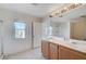 Bathroom featuring dual sinks, a large mirror and a bathtub at 10505 Cold Mountain Ave, Las Vegas, NV 89129