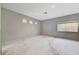 Large bedroom with multiple windows and gray walls awaiting renovation at 10505 Cold Mountain Ave, Las Vegas, NV 89129