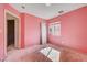 Bedroom featuring pink walls, one window, and an open door at 10505 Cold Mountain Ave, Las Vegas, NV 89129