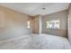 Large living room with gray walls, tiled entryway and large windows awaiting renovation at 10505 Cold Mountain Ave, Las Vegas, NV 89129