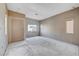 Large living room with gray walls, tiled entryway and large windows awaiting renovation at 10505 Cold Mountain Ave, Las Vegas, NV 89129