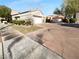 Street view of home with a two-car garage and landscaped front at 10524 India Hawthorn Ave, Las Vegas, NV 89144