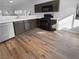 Clean kitchen featuring dark cabinetry, stainless steel appliances, and wood flooring at 10524 India Hawthorn Ave, Las Vegas, NV 89144