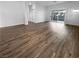 Open living area featuring wood-look flooring and sliding glass doors at 10524 India Hawthorn Ave, Las Vegas, NV 89144