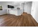 Open-concept living space featuring wood-look floors, breakfast bar, and ample natural light at 10524 India Hawthorn Ave, Las Vegas, NV 89144
