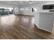 Open-concept living room with wood floors flowing into an adjacent kitchen area at 10524 India Hawthorn Ave, Las Vegas, NV 89144