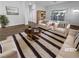 Bright, staged living room with sliding glass doors and contemporary furnishings at 10524 India Hawthorn Ave, Las Vegas, NV 89144