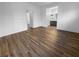 Spacious main bedroom area showing wood-look flooring and access to bathroom at 10524 India Hawthorn Ave, Las Vegas, NV 89144