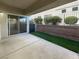 Covered patio area with artificial turf and sliding glass door access at 10524 India Hawthorn Ave, Las Vegas, NV 89144