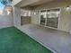 View of the covered patio featuring a sliding glass door and low-maintenance turf at 10524 India Hawthorn Ave, Las Vegas, NV 89144