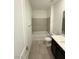 Bathroom with a bath tub, a sink with dark cabinets and tile flooring at 11443 Ethereal Landing Ave, Las Vegas, NV 89138