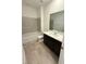 Bathroom with a bath tub, a sink with dark cabinets and tile flooring at 11443 Ethereal Landing Ave, Las Vegas, NV 89138