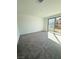 Spacious carpeted bedroom with a sliding glass door and ample natural light, perfect for relaxation at 11443 Ethereal Landing Ave, Las Vegas, NV 89138