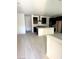 Open-concept kitchen with a large island, stainless steel hood, dark wood cabinets and hardwood floors at 11443 Ethereal Landing Ave, Las Vegas, NV 89138