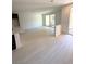 Bright, open living space with hardwood floors leading to the kitchen and patio at 11443 Ethereal Landing Ave, Las Vegas, NV 89138