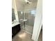 Shower with glass doors, shower head, and tile surround at 11443 Ethereal Landing Ave, Las Vegas, NV 89138