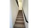Carpeted staircase with black railing leading to the upper level, providing comfortable access at 11443 Ethereal Landing Ave, Las Vegas, NV 89138