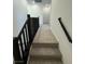 Carpeted staircase with black railing leading to the upper level, providing comfortable access at 11443 Ethereal Landing Ave, Las Vegas, NV 89138