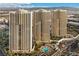 A mid-level shot showing three high-rise condos with swimming pools in a resort-style living arrangement at 125 E Harmon Ave # 2521, Las Vegas, NV 89109