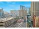 Buildings surround an outdoor parking lot with greenery and city views at 135 E Harmon Ave # 1005, Las Vegas, NV 89109