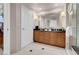 Well-lit bathroom features a double sink vanity, glass shower, and contemporary design elements at 135 E Harmon Ave # 1007, Las Vegas, NV 89109