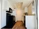 Efficient kitchen featuring white cabinets, granite counters, wood floors and black appliances at 1405 Vegas Valley Dr # 357, Las Vegas, NV 89169