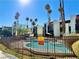 Community pool surrounded by a secure fence and lush palm trees at 1405 Vegas Valley Dr # 357, Las Vegas, NV 89169