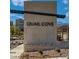 Community sign says 'Quail Cove' in a modern font and style with landscaping at 1513 Bat Hawk St, Las Vegas, NV 89144