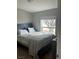 Bedroom featuring a bed with a decorative headboard and a view of a large tree outside the window at 1640 E Kearney St, Pahrump, NV 89048