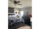 Spacious bedroom with ceiling fan, decorated with a flag, hats, photos and teddy bear at 1640 E Kearney St, Pahrump, NV 89048