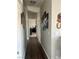 Hallway with wood flooring, grey walls, and modern artwork leading to other rooms at 1640 E Kearney St, Pahrump, NV 89048