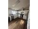 Bright kitchen featuring white cabinets, stainless steel appliances, and stylish wood-look flooring at 1640 E Kearney St, Pahrump, NV 89048